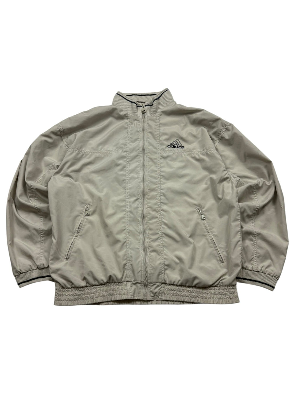 Beige Adidas Vintage Trackjacket mit dunkel eingefasstem Rippkragen, Brustlogo und Zip-Taschen