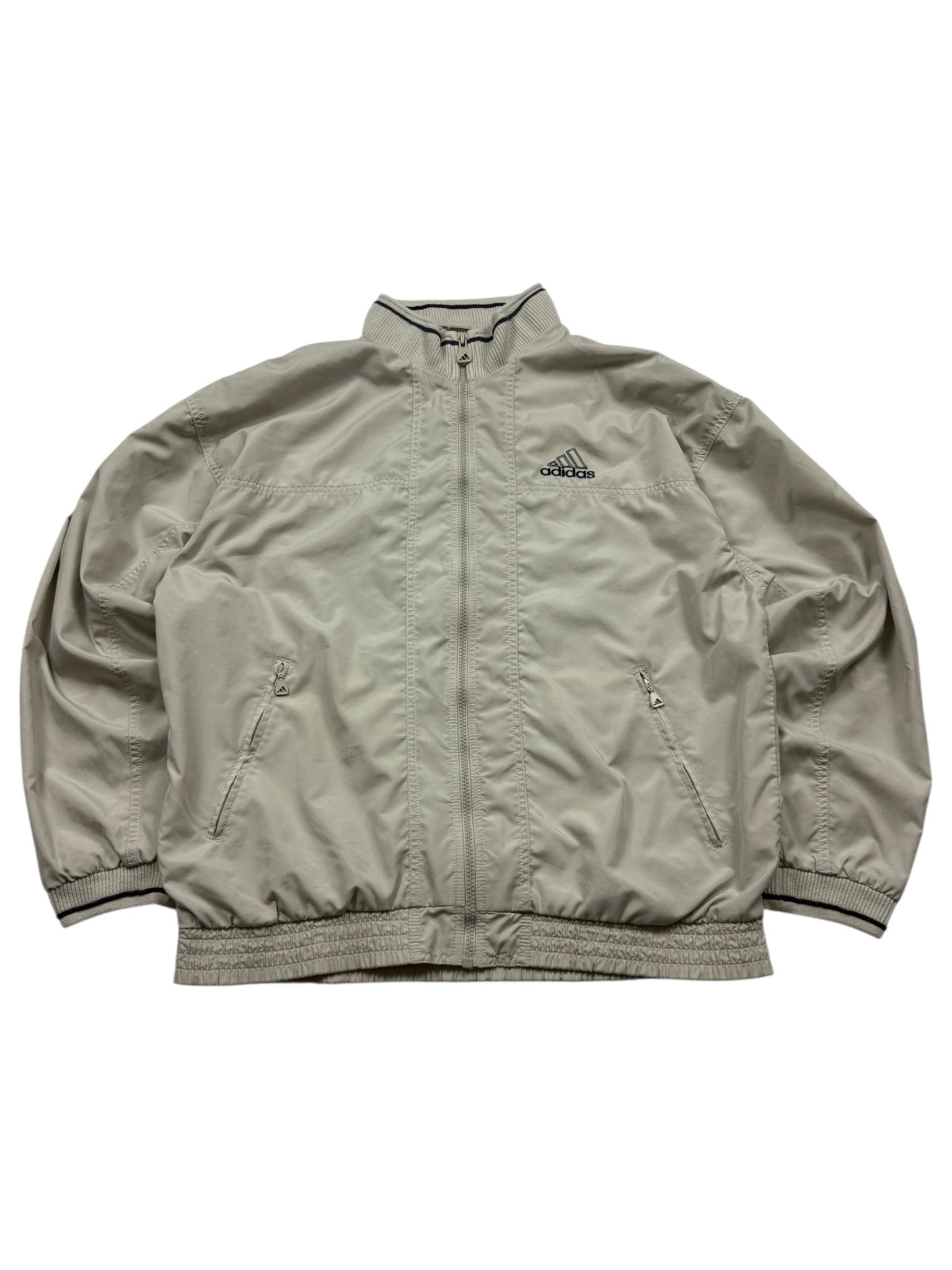Beige Adidas Vintage Trackjacket mit dunkel eingefasstem Rippkragen, Brustlogo und Zip-Taschen